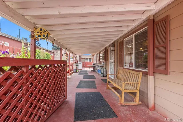 a view of a balcony with furniture and wooden floor