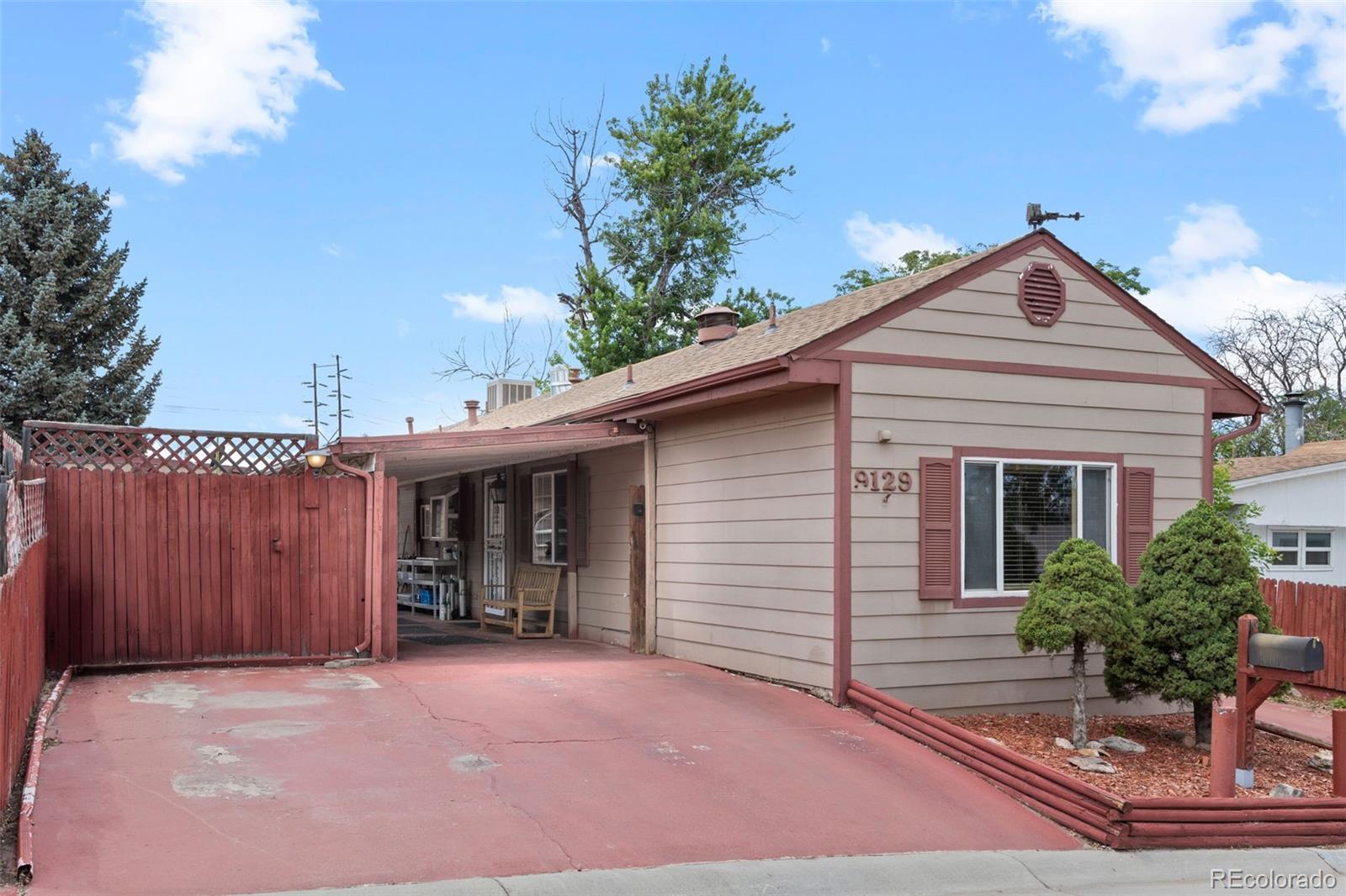 9129 Rampart Street Denver, CO 80260 - Photo 2 of 27 a view of a house with a backyard and entryway