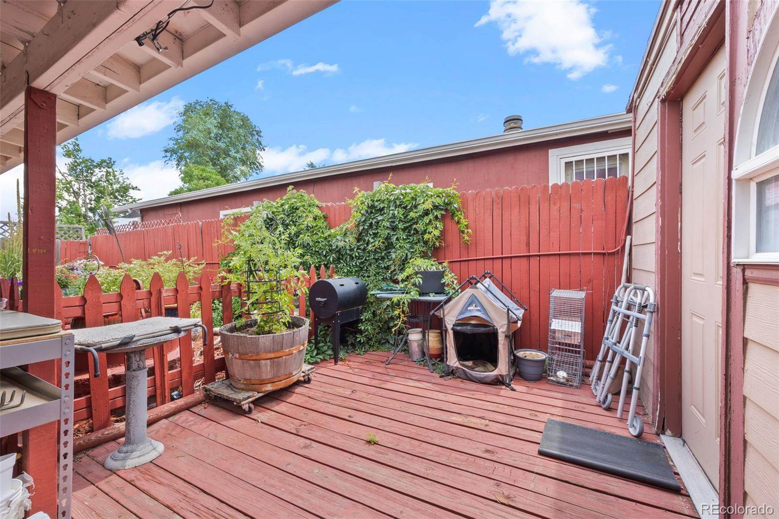 9129 Rampart Street Denver, CO 80260 - Photo 21 of 27 a view of a balcony with furniture and wooden floor