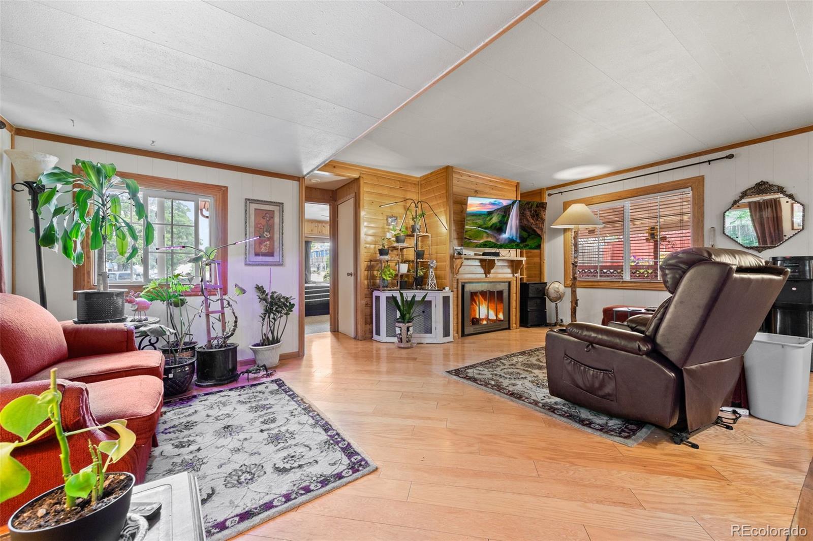 9129 Rampart Street Denver, CO 80260 - Photo 6 of 27 a living room with furniture and a large window