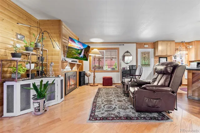 a living room with furniture fireplace and potted plants