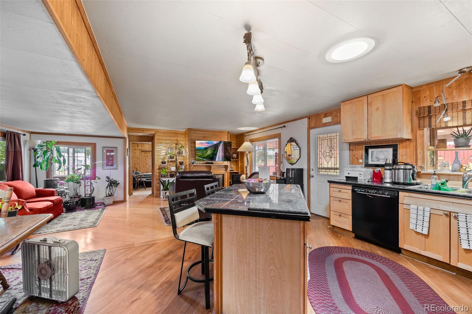 9129 Rampart Street Denver, CO 80260 - Photo 9 of 27 a view of a dining room with furniture window and wooden floor