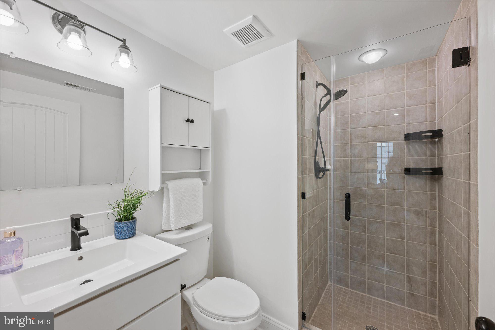 660 Morton Place Northeast, Unit 5 Washington, DC 20002 - Photo 17 of 21 a bathroom with a sink toilet and shower