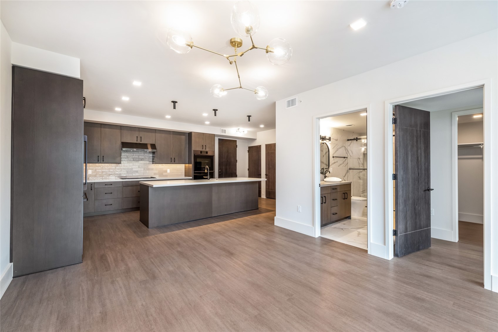 80 West Main Street, Unit 201 Frisco, CO 80443 - Photo 5 of 27 a large kitchen with stainless steel appliances kitchen island a large counter top and a wooden floors