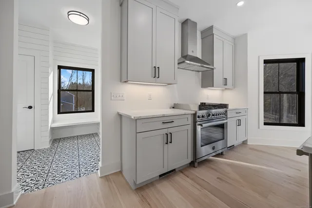 a kitchen with stainless steel appliances a stove a sink and a refrigerator
