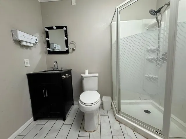 a bathroom with a toilet and a shower