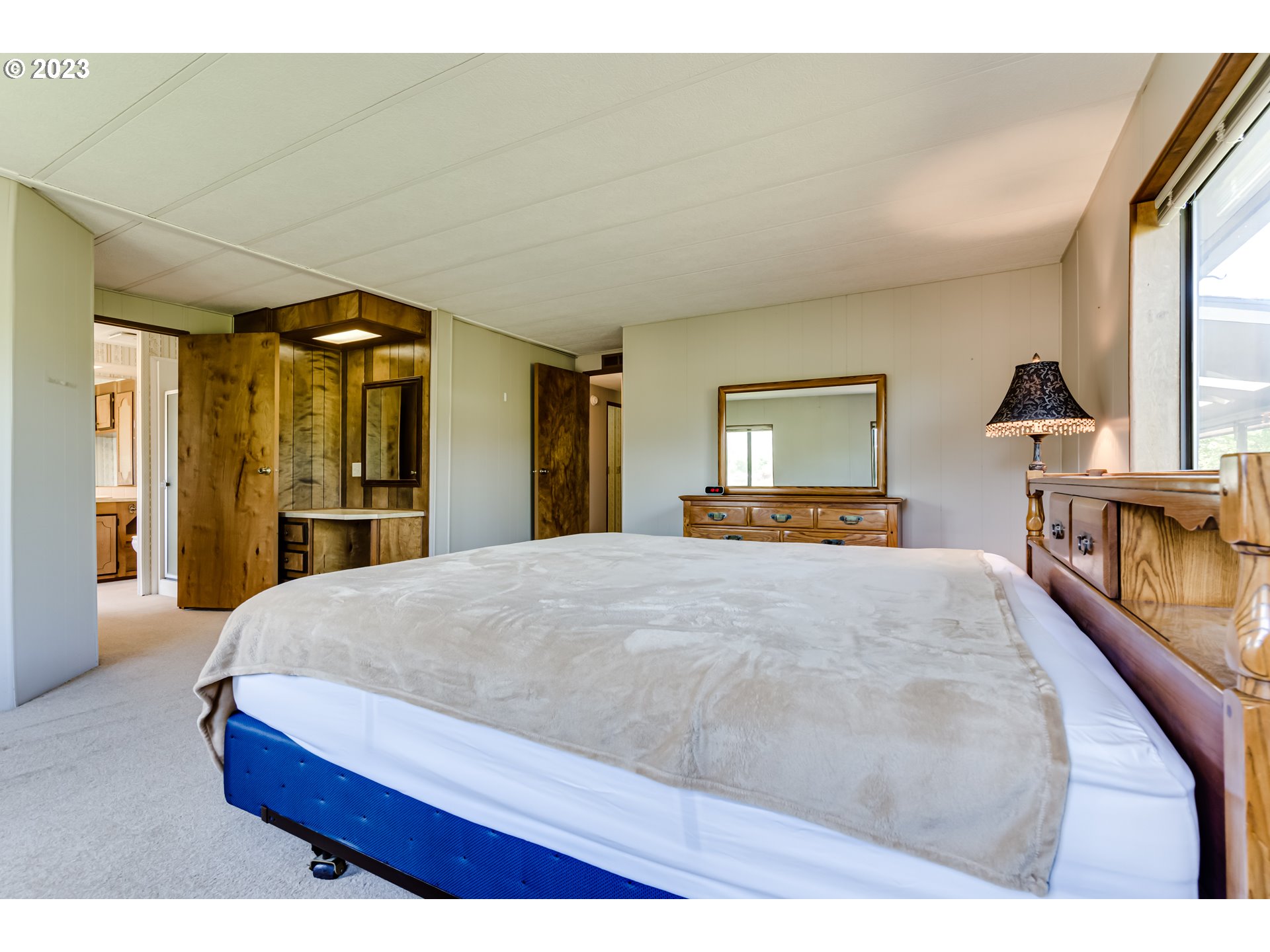 34637 Devonshire Drive Eugene, OR 97405 - Photo 19 of 37 a bedroom with a large bed and a large window