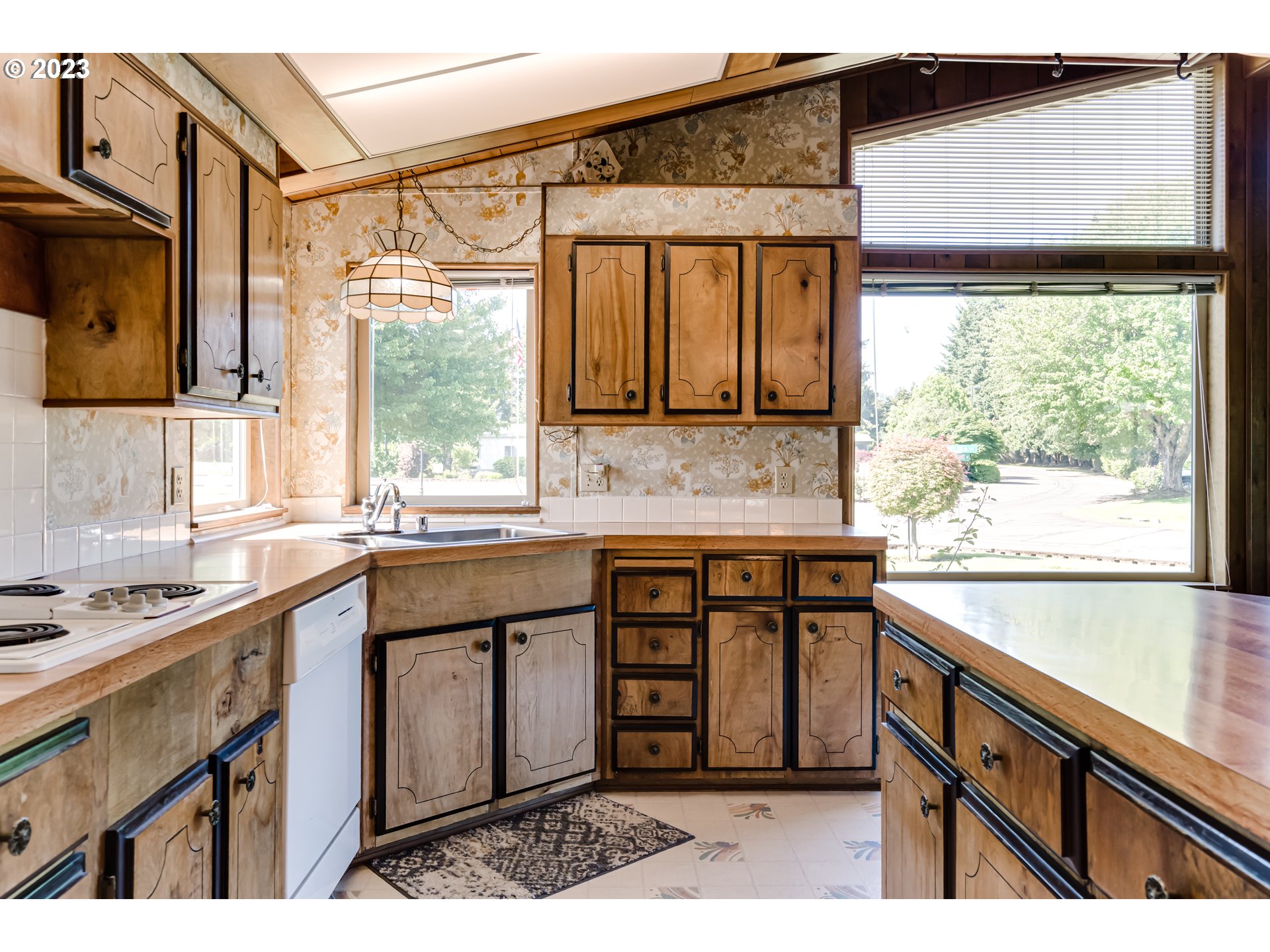 34637 Devonshire Drive Eugene, OR 97405 - Photo 7 of 37 a kitchen with stainless steel appliances kitchen island granite countertop a sink and cabinets