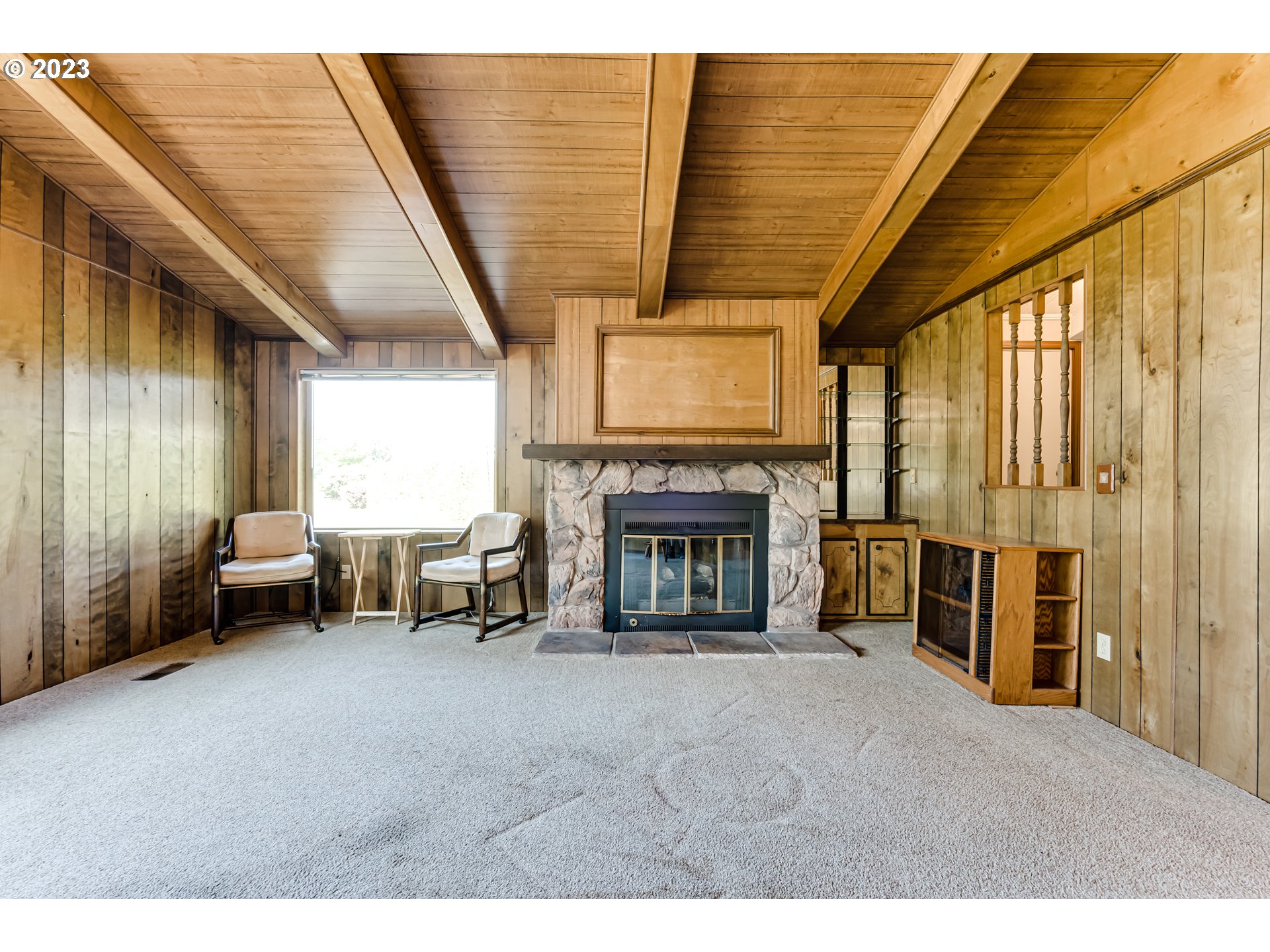 34637 Devonshire Drive Eugene, OR 97405 - Photo 8 of 37 a living room with furniture a fireplace and a large window