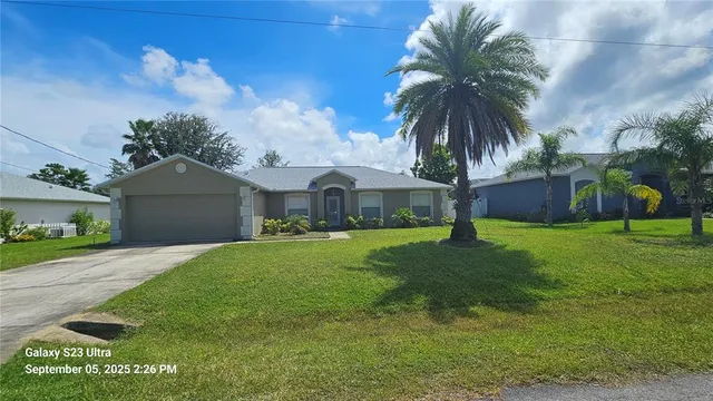 a front view of house with yard and green space
