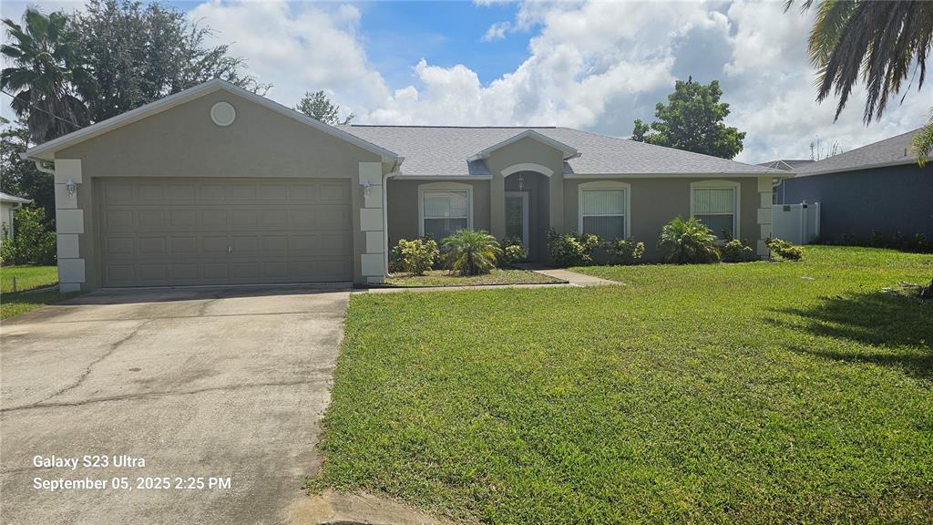 33 Fenwick Lane Palm Coast, FL 32137 - Photo 2 of 16 a front view of a house with a yard