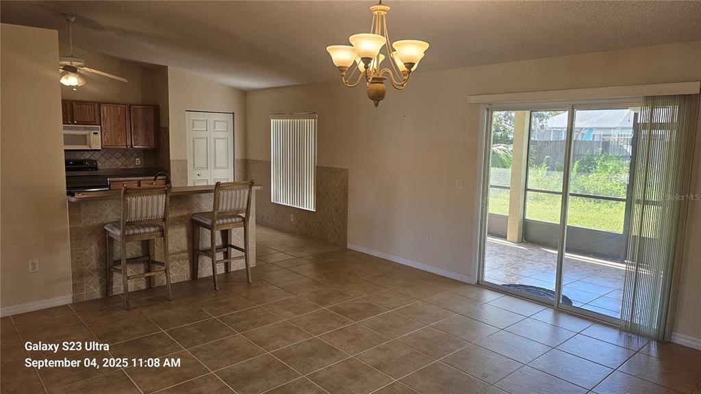 33 Fenwick Lane Palm Coast, FL 32137 - Photo 4 of 16 a view of a dining room with furniture a chandelier and window