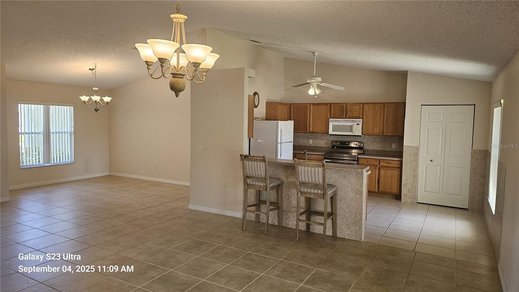 33 Fenwick Lane Palm Coast, FL 32137 - Photo 8 of 16 a kitchen with stainless steel appliances granite countertop a refrigerator and a stove top oven