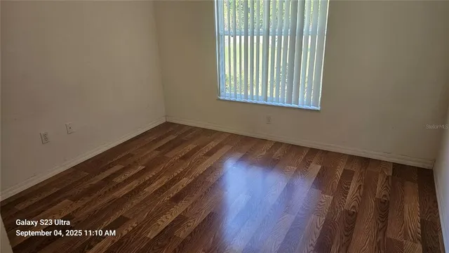a view of an empty room and wooden floor