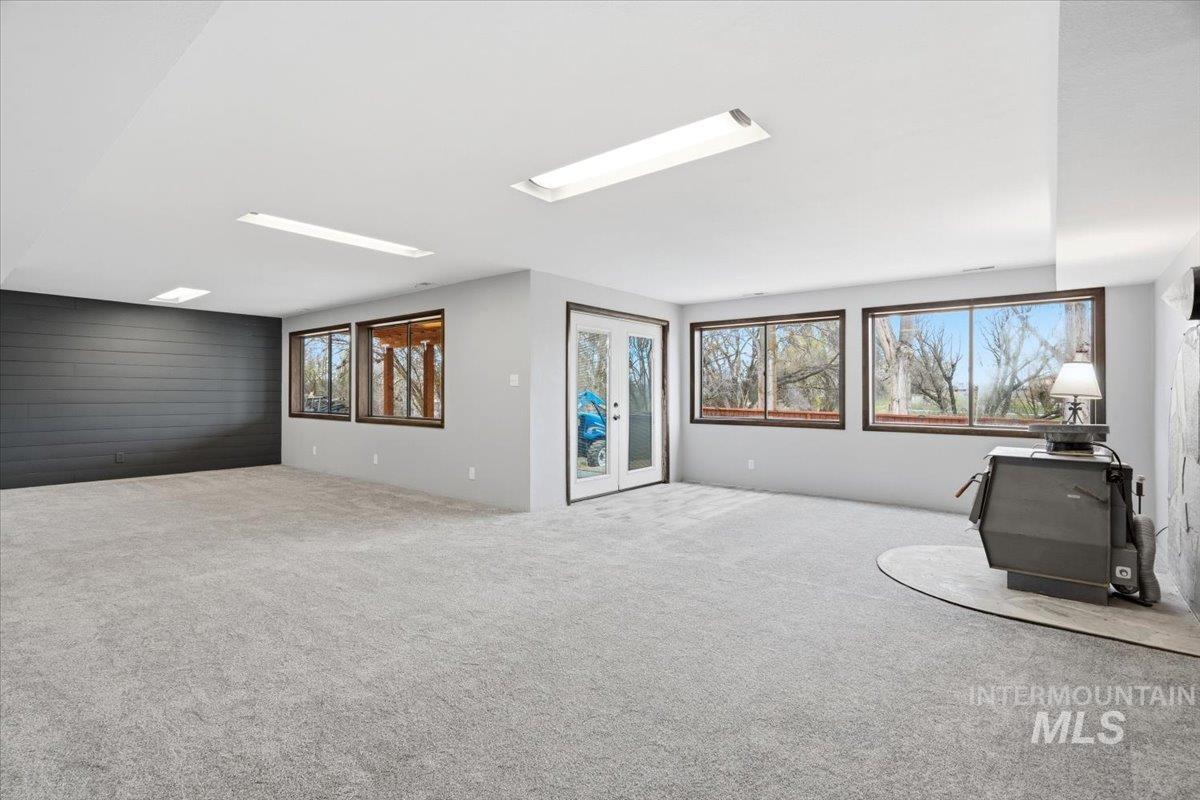 7771 Elmore Road Fruitland, ID 83619 - Photo 19 of 48 Below grade area with french doors and carpet