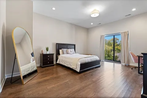 a bedroom with a bed and a chair