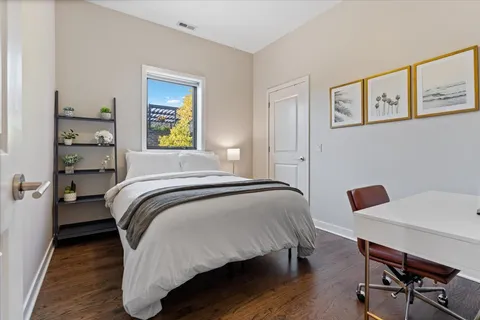 a bedroom with a bed and a table in it