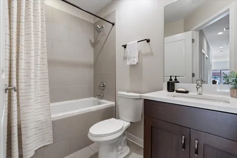 a bathroom with a sink toilet a mirror and shower