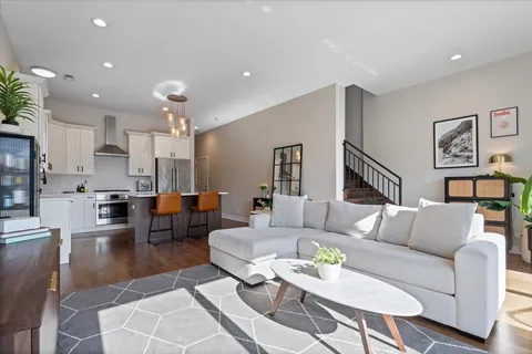 a living room with furniture kitchen view and a table