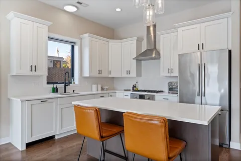 a kitchen with stainless steel appliances a sink stove and refrigerator