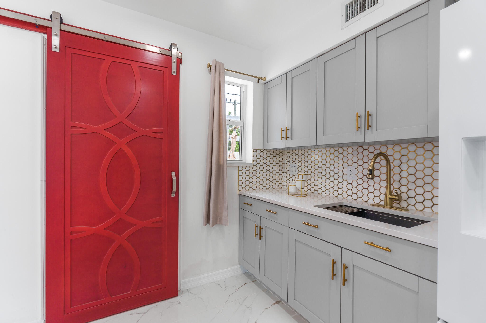 201 Northeast 28th Court Boynton Beach, FL 33435 - Photo 17 of 48 a kitchen with a sink and cabinets