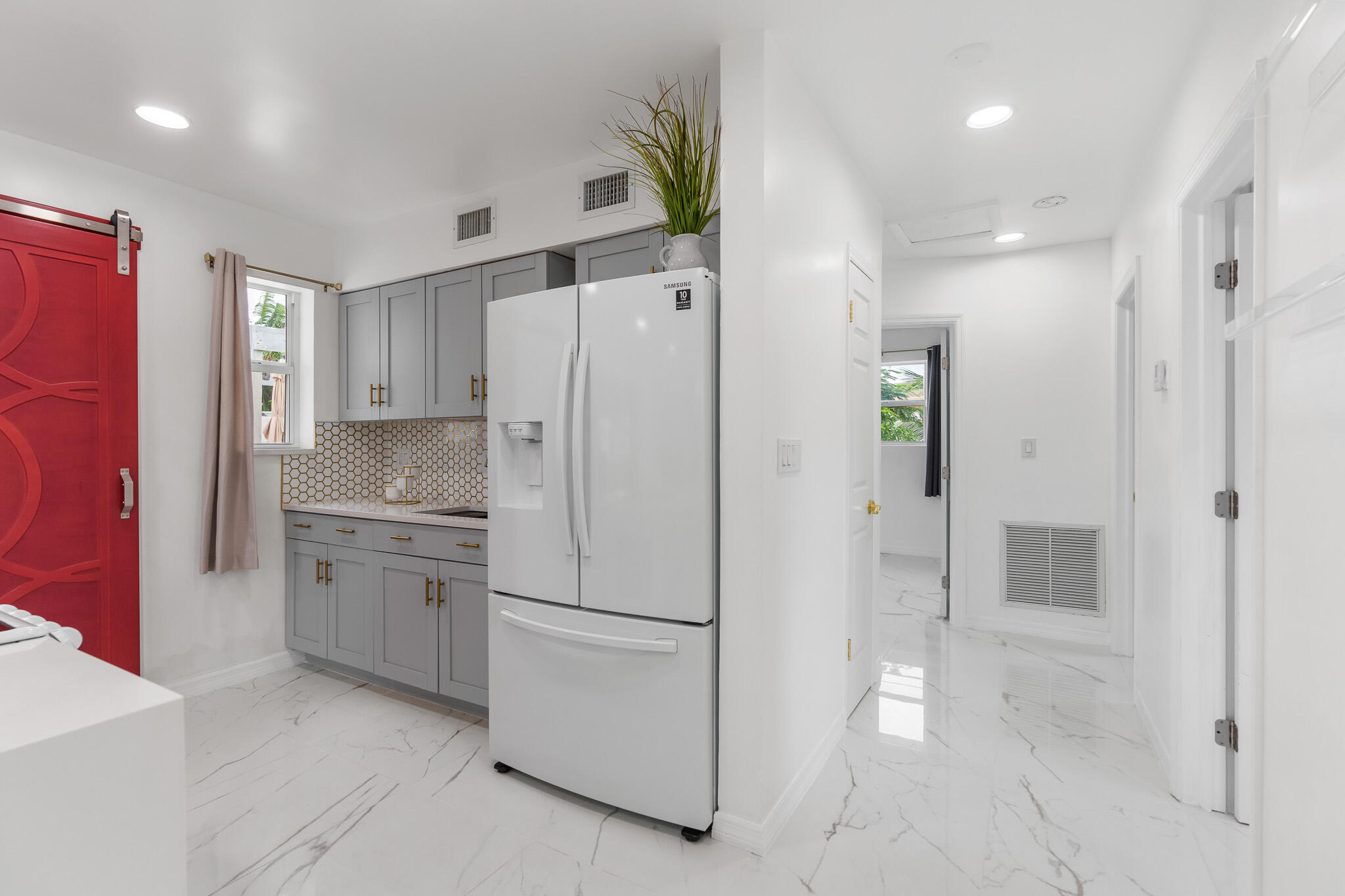 201 Northeast 28th Court Boynton Beach, FL 33435 - Photo 20 of 48 a kitchen with a refrigerator and a sink