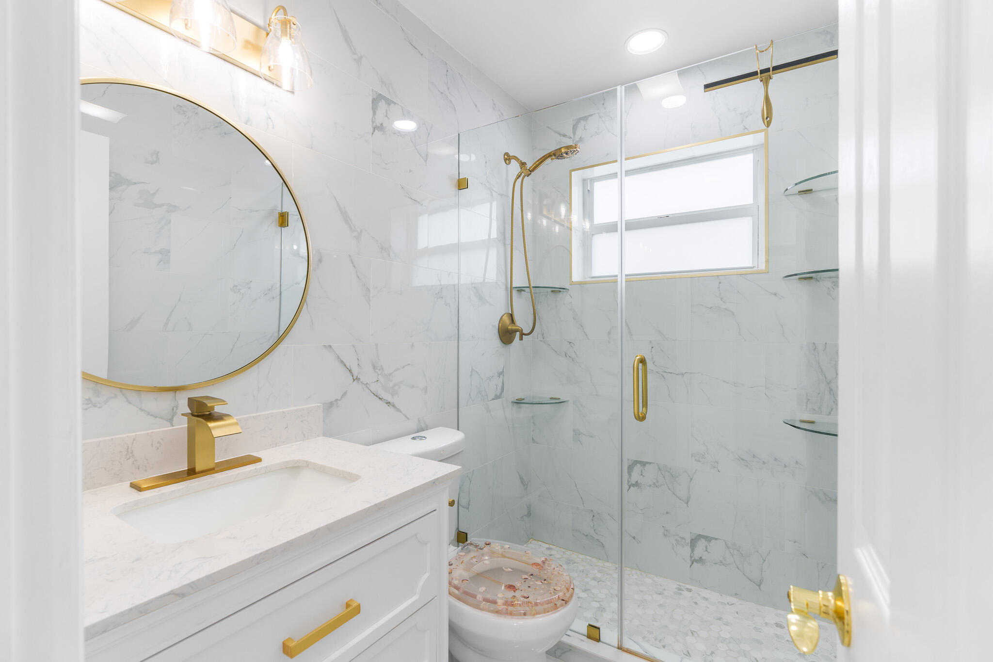 201 Northeast 28th Court Boynton Beach, FL 33435 - Photo 21 of 48 a bathroom with a sink mirror vanity and toilet