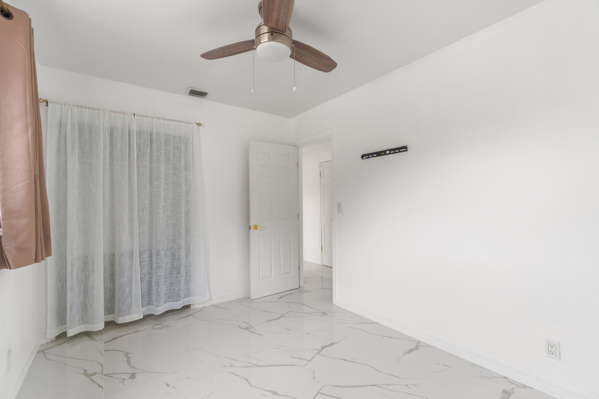 201 Northeast 28th Court Boynton Beach, FL 33435 - Photo 26 of 48 an empty room with a ceiling fan