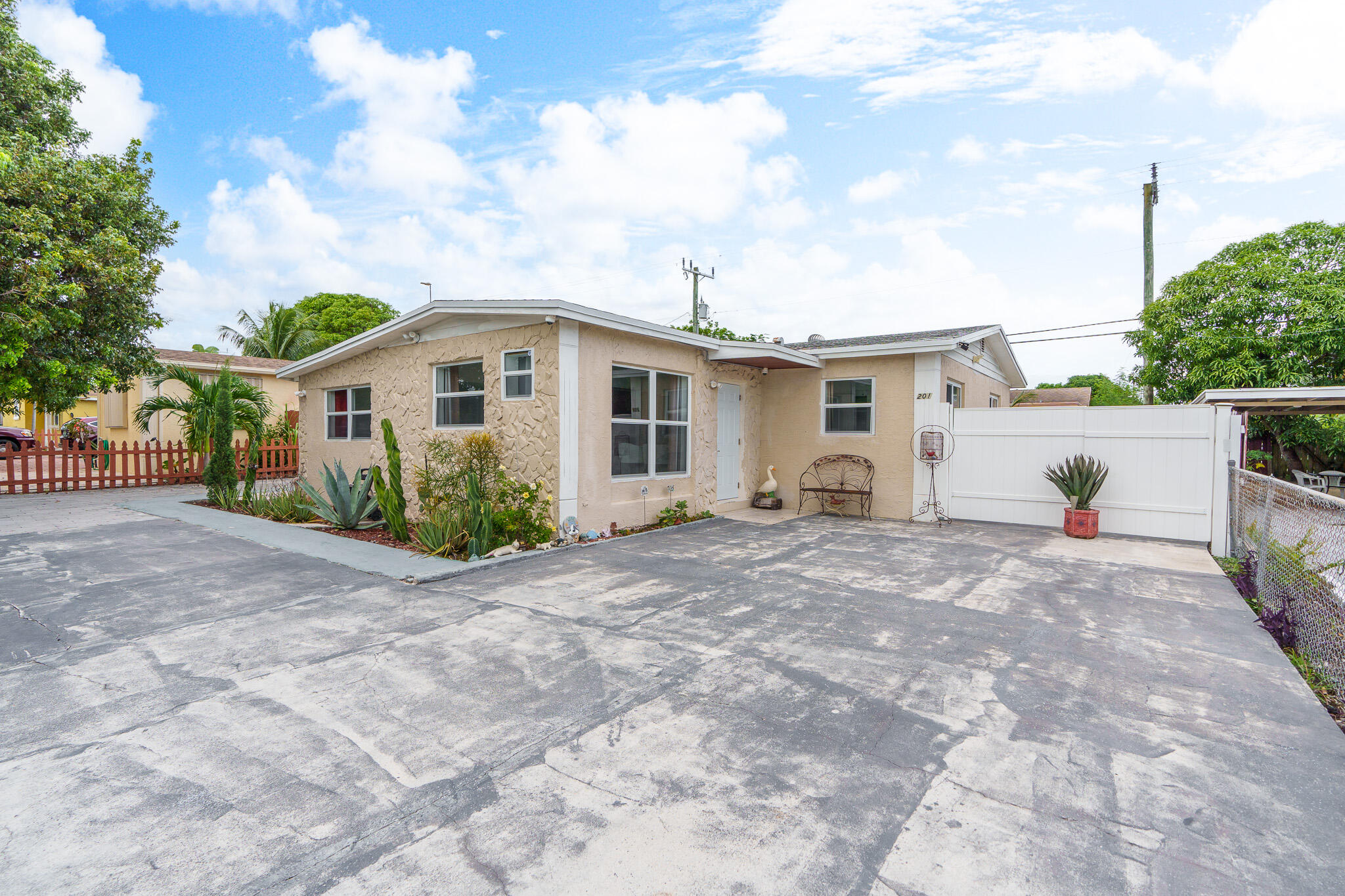 201 Northeast 28th Court Boynton Beach, FL 33435 - Photo 37 of 48 a view of a white house with a yard and plants