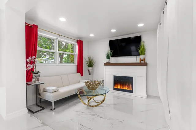 a view of kitchen with furniture and refrigerator