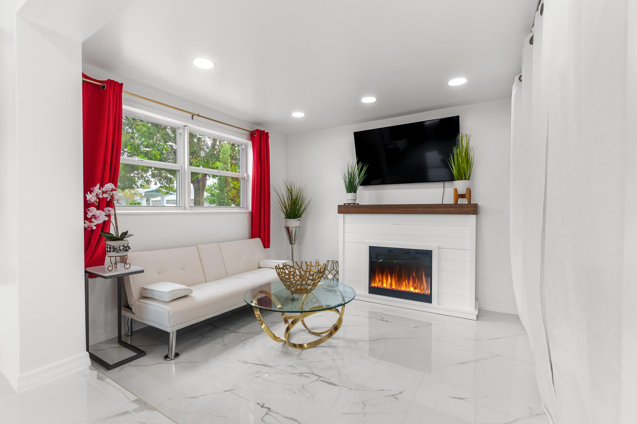 201 Northeast 28th Court Boynton Beach, FL 33435 - Photo 8 of 48 a living room with furniture a flat screen tv and a fireplace