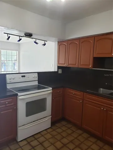 a stove top oven sitting inside of a kitchen