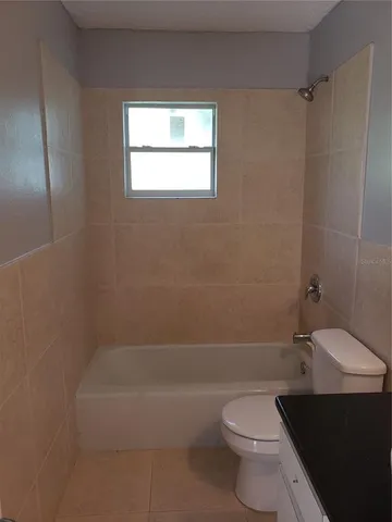 a bathroom with a toilet a sink and bathtub