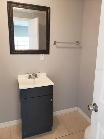 a bathroom with a sink a mirror and vanity