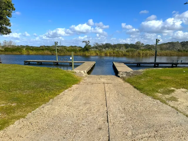 a view of a water pond with green yard