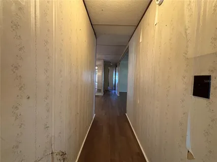 a view of a hallway with wooden floor