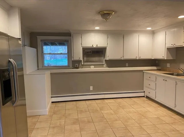 a view of kitchen with stainless steel appliances granite countertop a refrigerator and a stove top oven