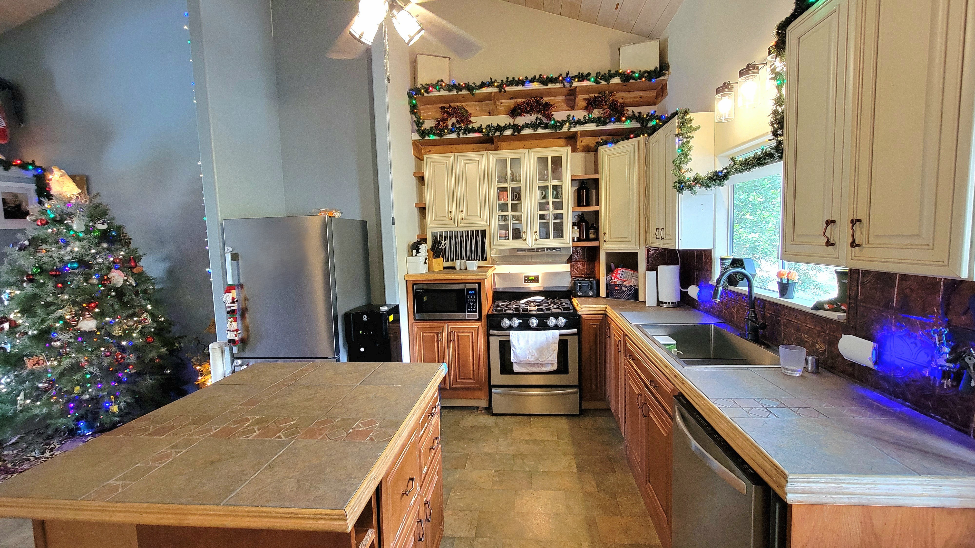 78-1392 Bishop Road Holualoa, HI 96725 - Photo 11 of 30 a kitchen with stainless steel appliances granite countertop a stove refrigerator and cabinets