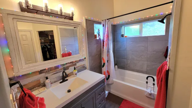 a bedroom with a bed and a flat tv screen on the dresser