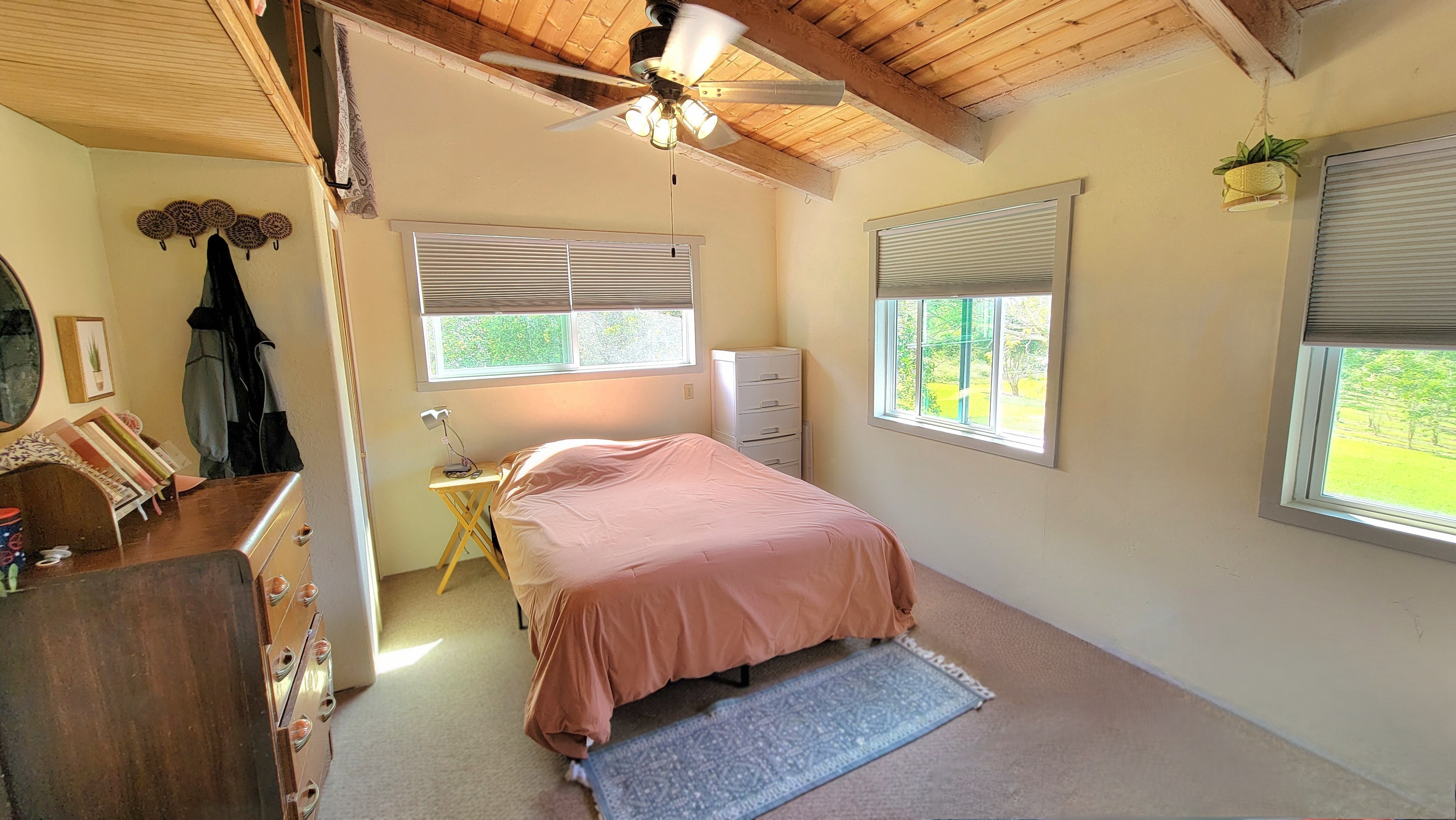 78-1392 Bishop Road Holualoa, HI 96725 - Photo 15 of 30 a bedroom with a bed a mirror and a window