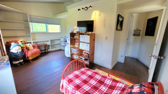 a bedroom with furniture and a wooden floor
