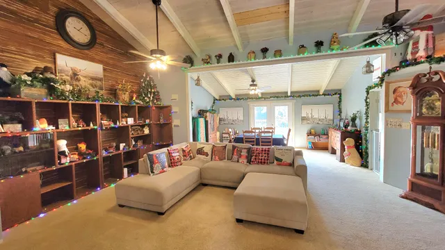 a view of a dining room with furniture and a chandelier