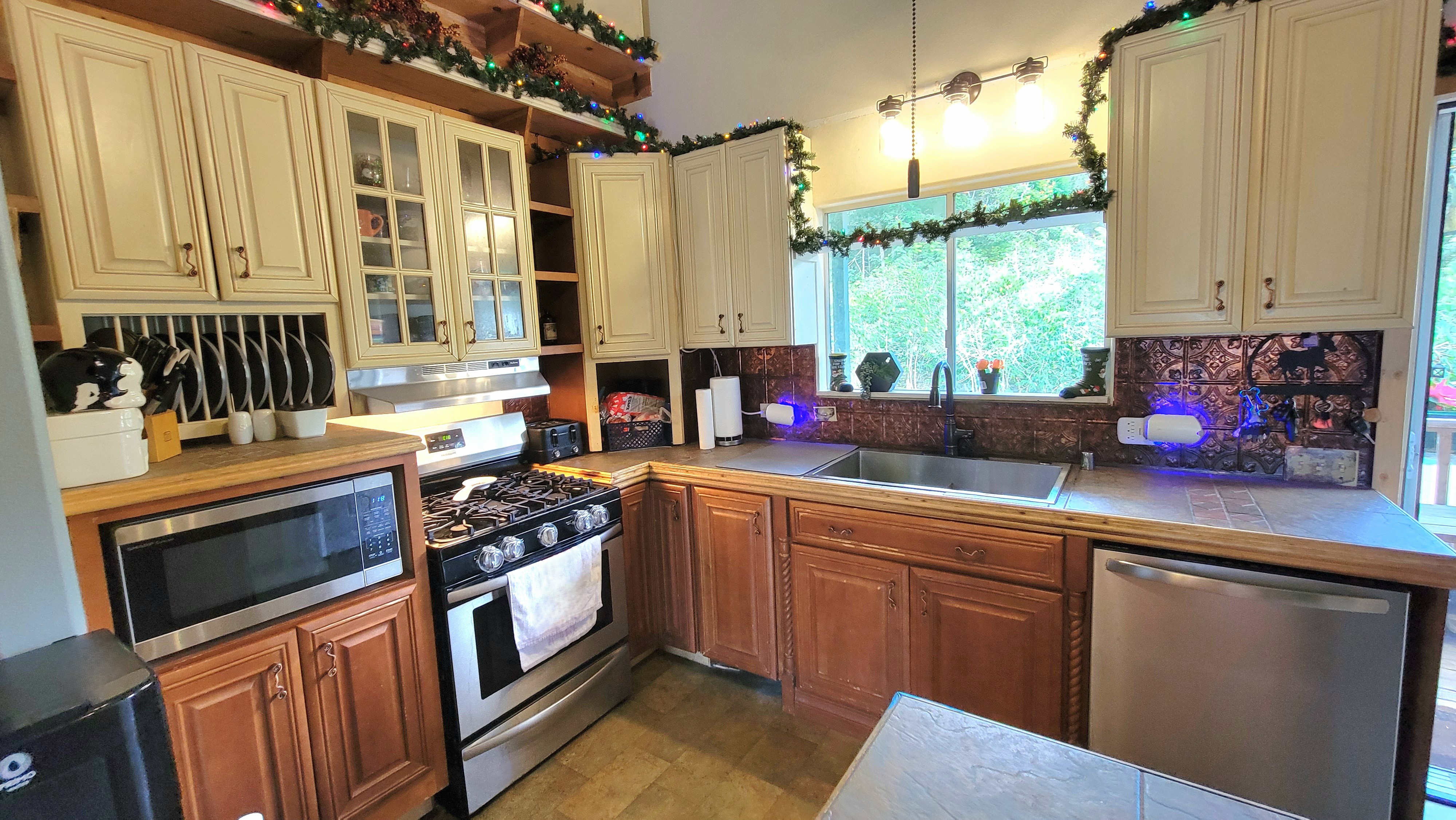 78-1392 Bishop Road Holualoa, HI 96725 - Photo 10 of 30 a kitchen with stainless steel appliances a stove sink and cabinets