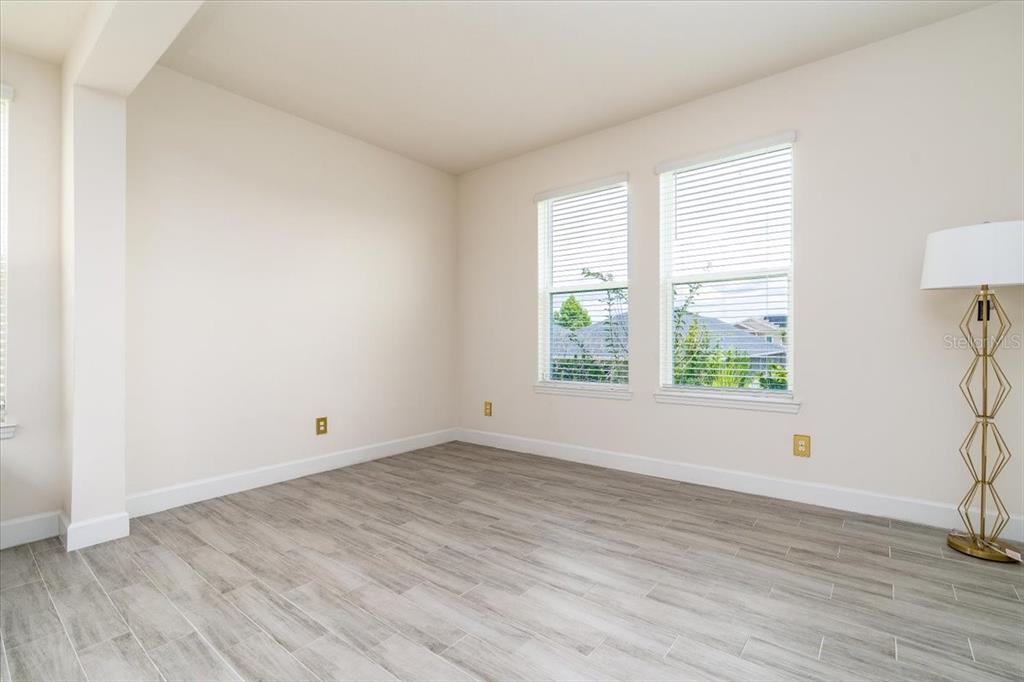 1296 Waterview Ridge Circle Apopka, FL 32703 - Photo 28 of 60 an empty room with wooden floor and windows
