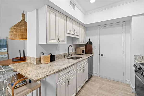 a kitchen with stainless steel appliances granite countertop a sink stove and cabinets
