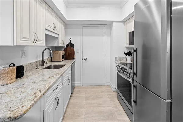 a kitchen with a refrigerator and a stove