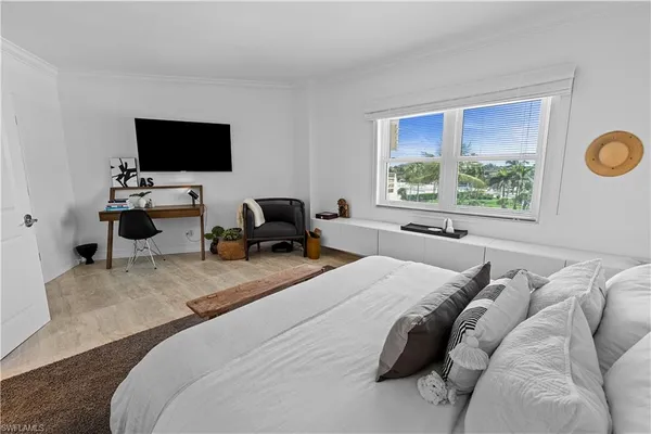 a bedroom with a bed lamp and a table