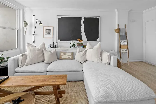 a living room with furniture a mirror and a flat screen tv
