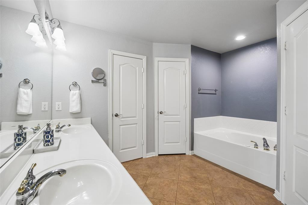 11211 Emerald Ranch Lane Forney, TX 75126 - Photo 24 of 35 Primary Bathroom featuring dual white sinks with chrome fixtures set in a white countertop