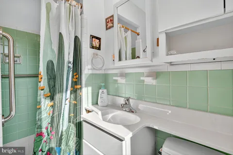 a bathroom with a sink vanity and a mirror